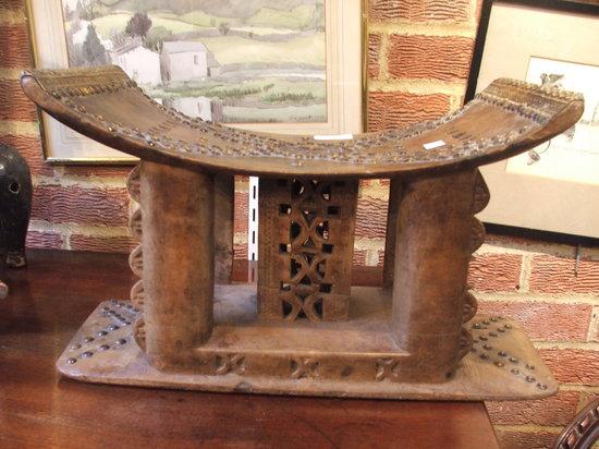 Appraisal: A NORTH AFRICAN LEATHER AND BRASS STUDDED STOOL on shaped