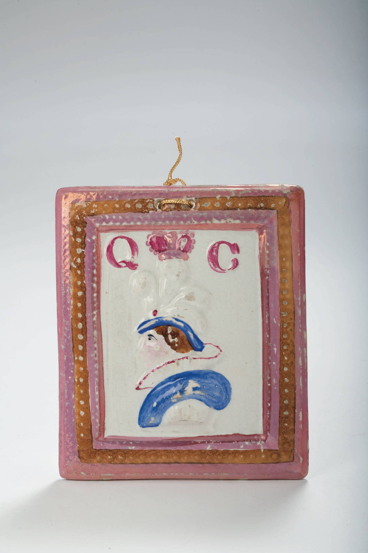 Appraisal: BRITISH PINK LUSTRE AND ENAMEL-DECORATED RELIEF PORTRAIT PLAQUE COMMEMORATING QUEEN