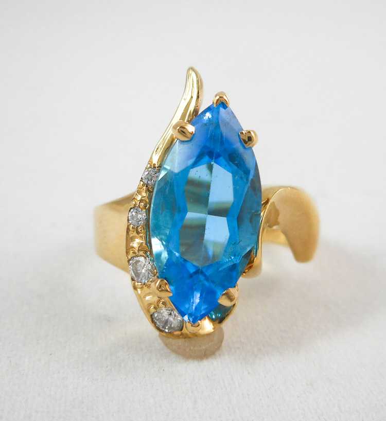 Appraisal: BLUE TOPAZ DIAMOND AND FOURTEEN KARAT GOLD RING with four