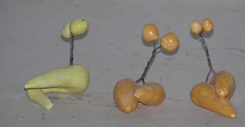 Appraisal: Three Small Biomorphic Sculptures in Yellow-Orange Ceramic on Ceramic Caplan