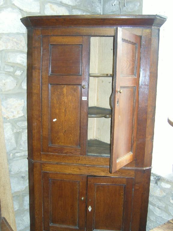 Appraisal: A Georgian oak free standing -tier corner cabinet enclosed by