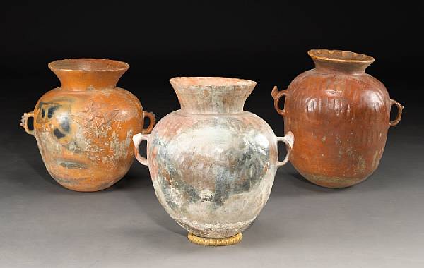 Appraisal: A group of three Spanish glazed terracotta storage jars late