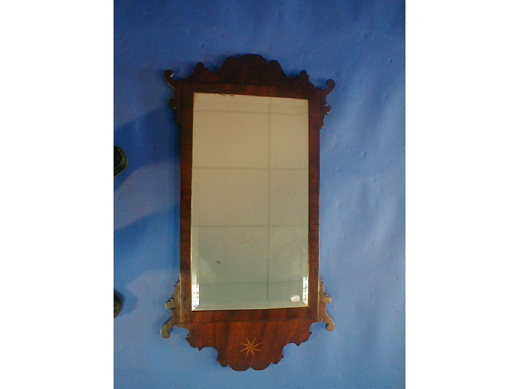 Appraisal: An th century mahogany framed wall mirror with bevelled glass