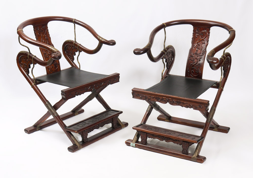 Appraisal: PAIR CARVED CHINESE HORSESHOE BACK FOLDING CHAIRS th century production