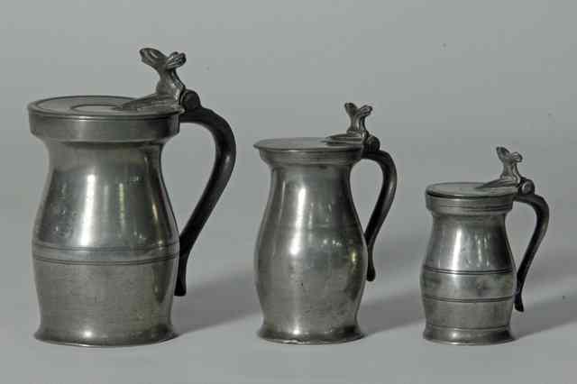 Appraisal: A matched set of three English pewter baluster lidded measures