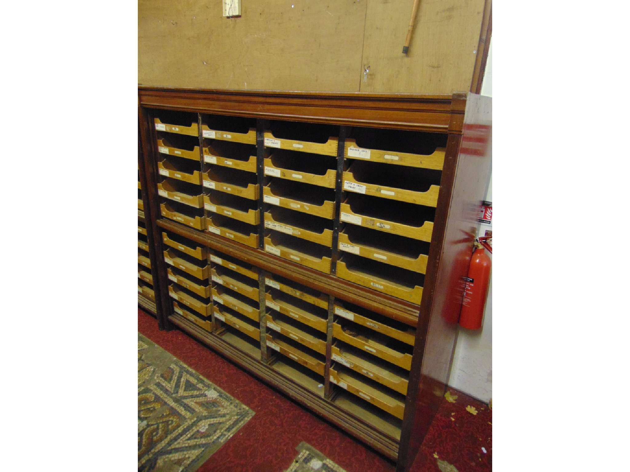 Appraisal: A vintage floorstanding haberdashery cabinet the moulded mahogany frame enclosing