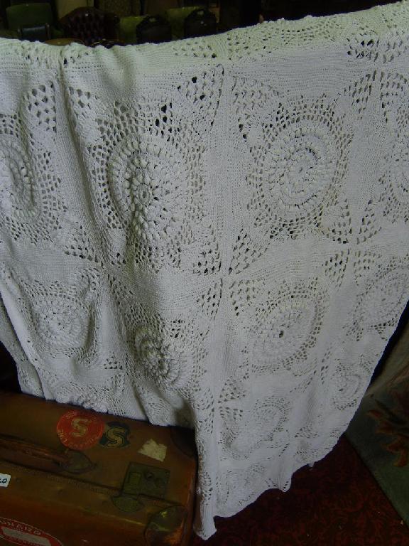 Appraisal: A white ground crochet bedcover with stylised floral decoration together