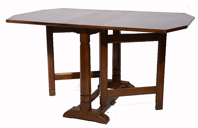 Appraisal: A Cotswold School oak gateleg dining tablethe top on octagonal