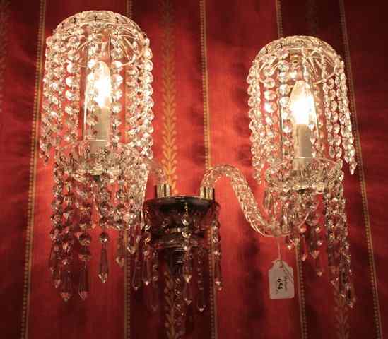 Appraisal: A PAIR OF CUT GLASS WALL LIGHTS with two scrolling