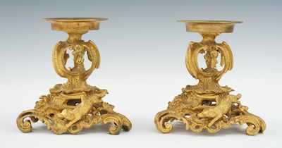 Appraisal: A Pair of Bronze Dore Rococo Holders Turned circular holders