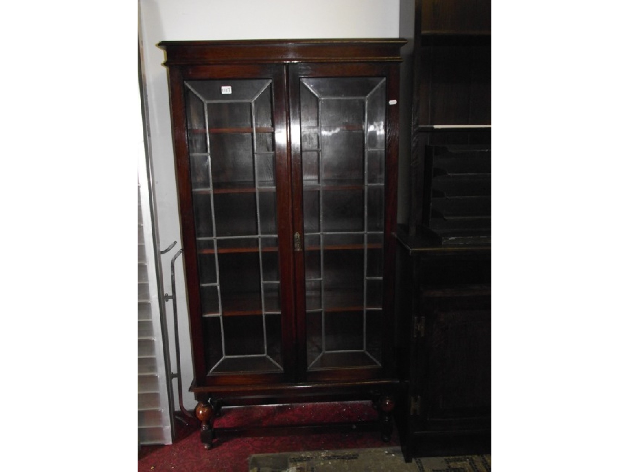 Appraisal: A s slim oak freestanding bookcase enclosed by a pair