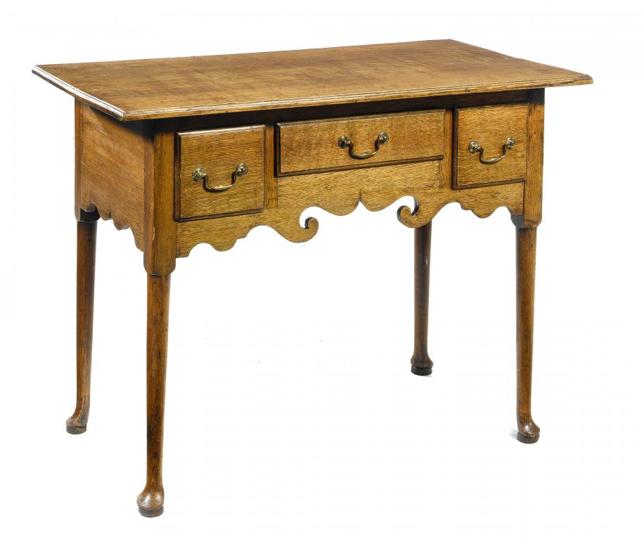 Appraisal: A GEORGE III OAK LOWBOY with oversailing top three moulded