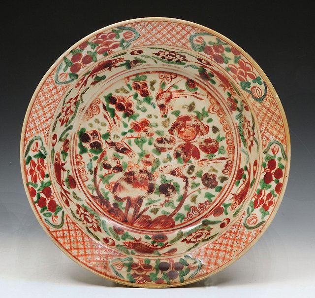 Appraisal: A CHINESE POLYCHROME SWATOW DISH decorated birds of paradise fruiting