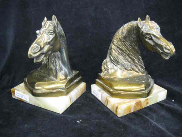 Appraisal: Pair of Bronzed Horsehead Bookends onyx bases deco era ''