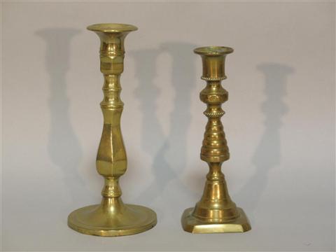 Appraisal: TWO BRASS CANDLESTICKS The taller with a faceted central section