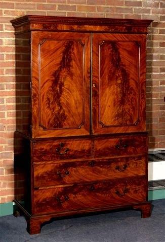 Appraisal: A GEORGE III MAHOGANY LINEN PRESS with dentil cornice two