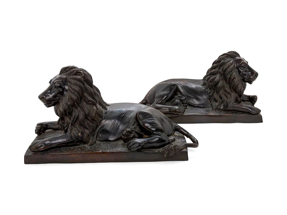 Appraisal: A Pair of Bronze Models of Recumbent Lions A Pair