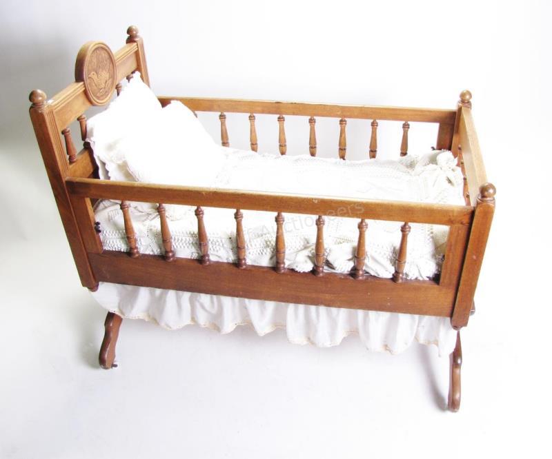 Appraisal: Antique ash baby cradle with carved medallion of bird at