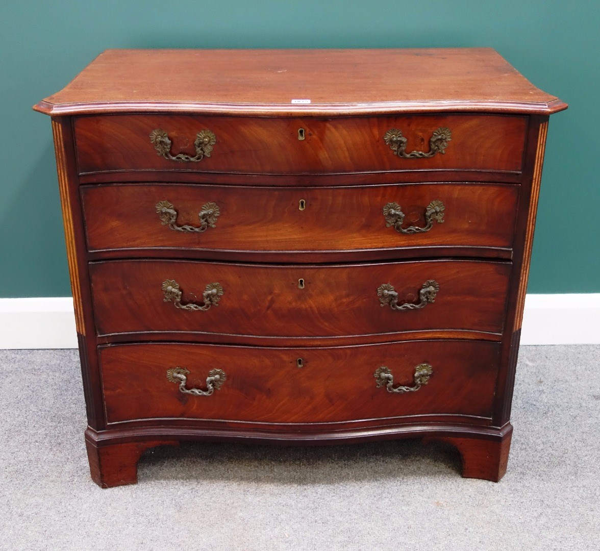 Appraisal: A mid th century mahogany serpentine chest of four long