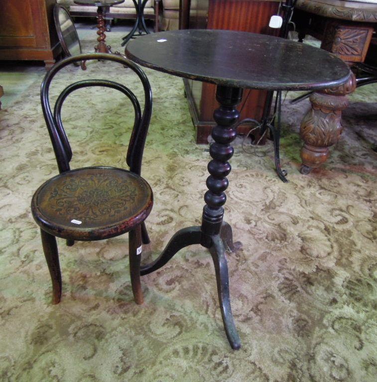 Appraisal: A Victorian ebonised snap top occasional table of circular form