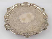 Appraisal: A Victorian silver waiter with shell and scroll rim on