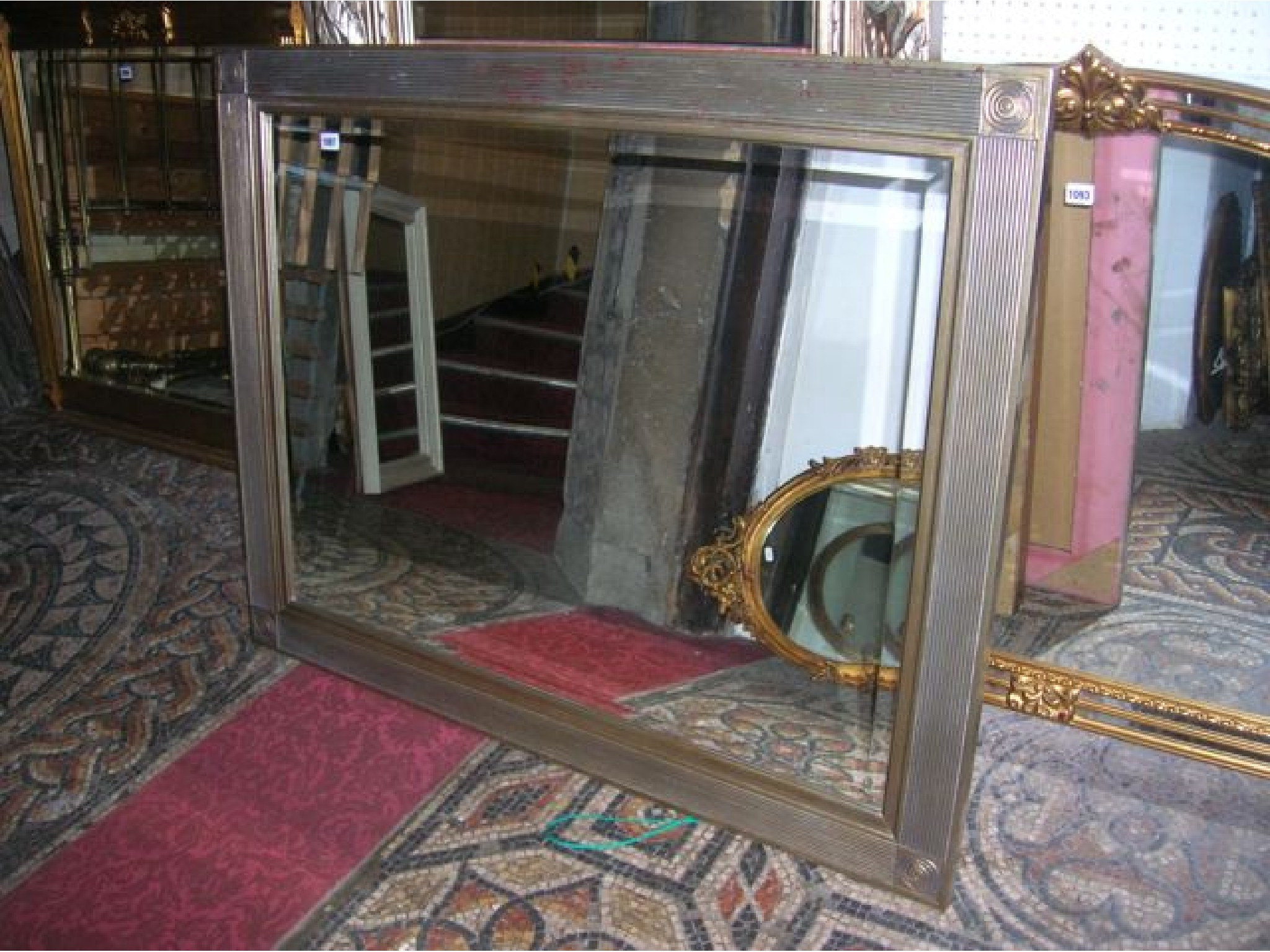 Appraisal: A contemporary reproduction wall mirror of rectangular form with bevelled