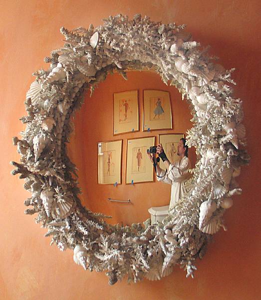 Appraisal: An Italian grotto style shell framed bullseye mirror height in