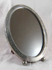 Appraisal: A large oval silver photo frame on ball feet with