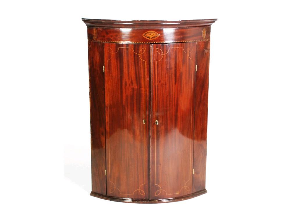 Appraisal: GEORGE III INLAID MAHOGANY BOW FRONTED MURAL CORNER CUPBOARD the