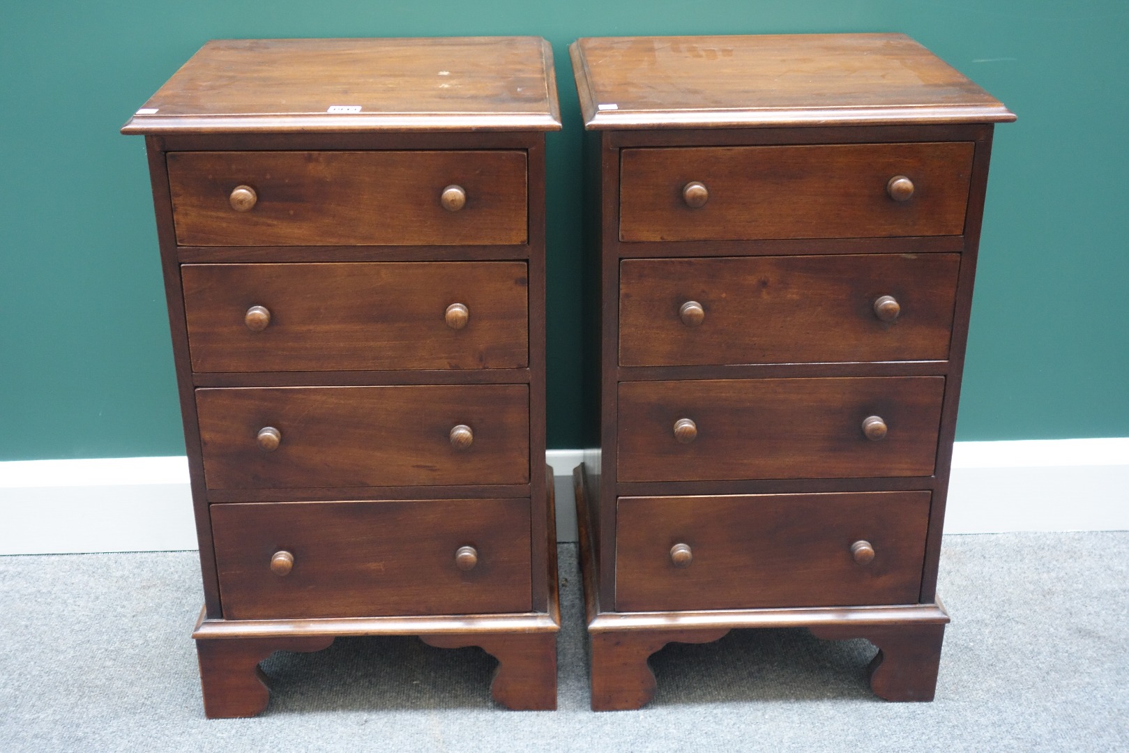 Appraisal: A pair of mahogany four drawer bedside tables of th