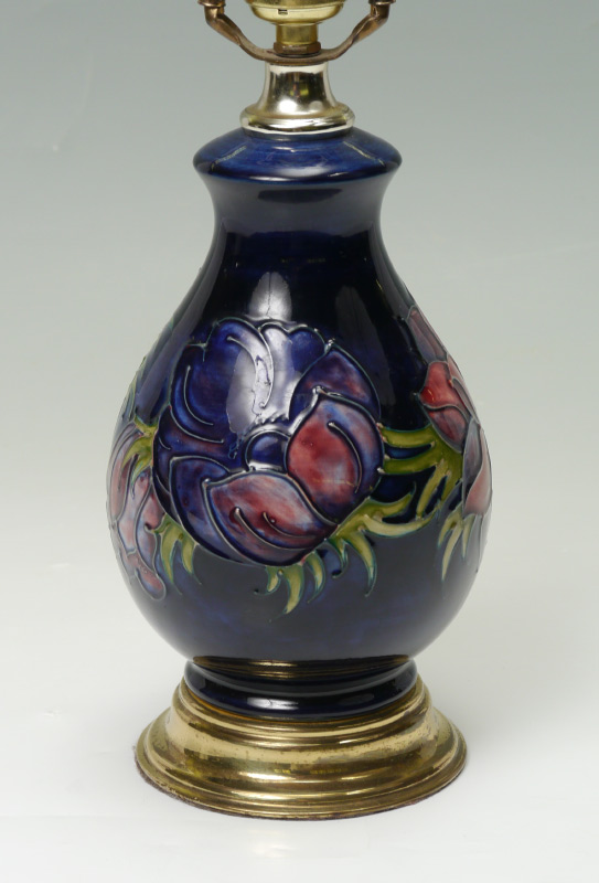 Appraisal: MOORCROFT POTTERY LAMP Floral motif brass base single socket fixture