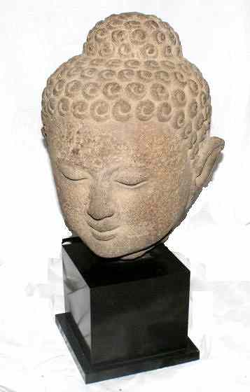 Appraisal: AN EARLY JAVANESE HEAVY STONE HEAD OF BUDDHA on a