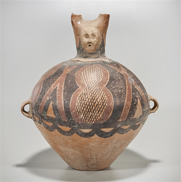 Appraisal: Chinese neolithic-style pottery vessel face form to neck polychrome body