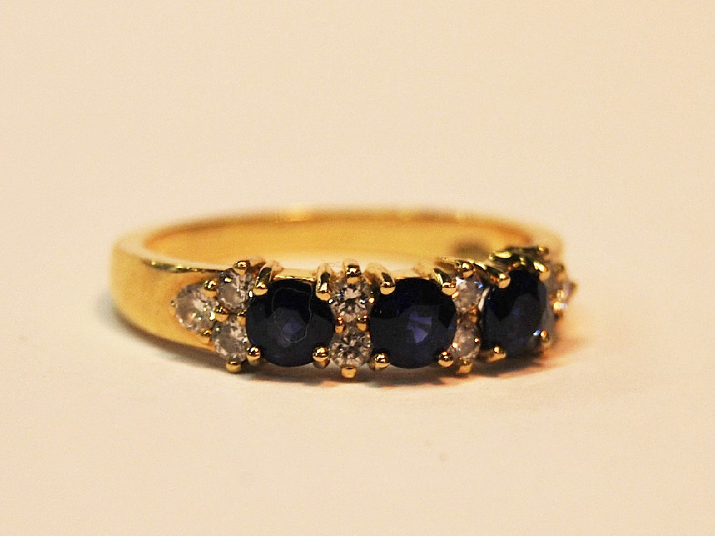 Appraisal: Sapphire and diamond thirteen stone half-hoop ring ct yellow gold