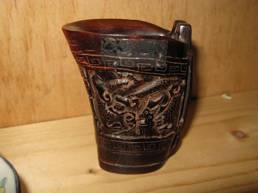 Appraisal: A carved rhinocerous horn pouring vessel handle in the form