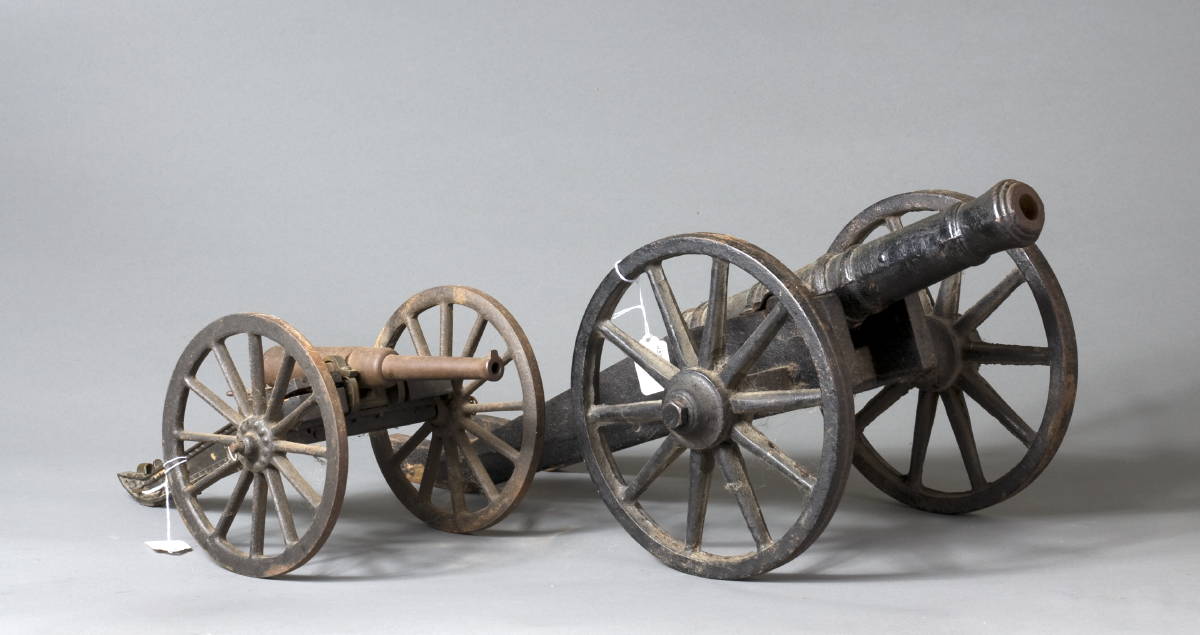 Appraisal: TWO MINIATURE IRON CANNONS CIRCA One with wooden mounted ammunition