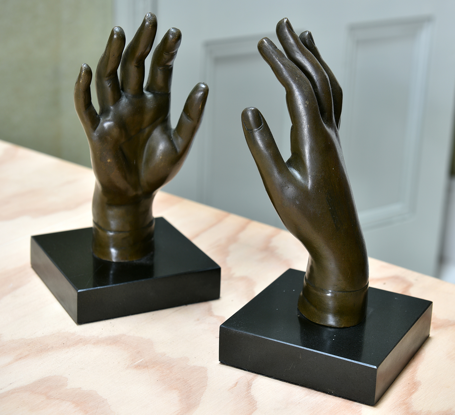 Appraisal: A PAIR OF BRONZE HANDS MOUNTED ON BLACK MARBLE BASES