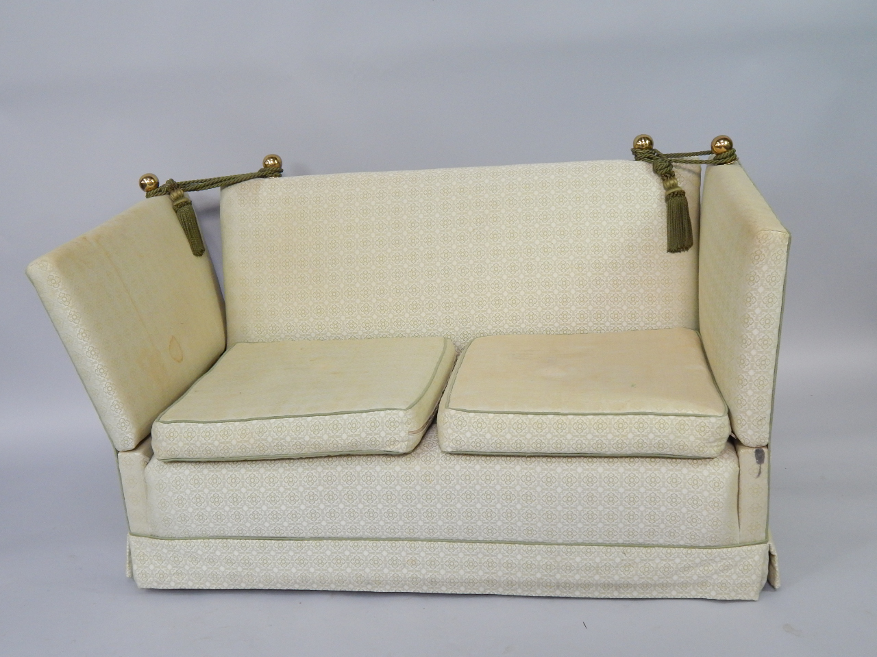 Appraisal: A Knowle two seater sofa upholstered in a green repeating