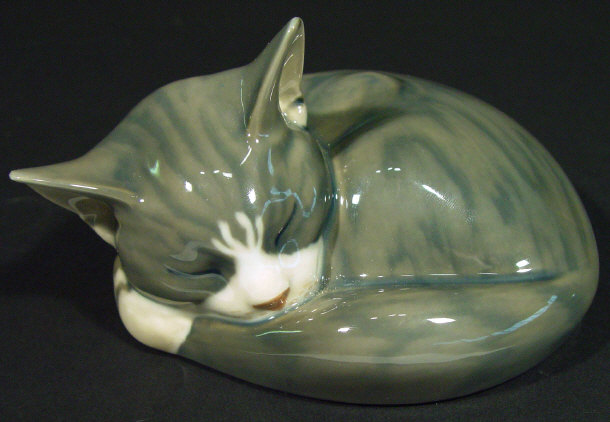 Appraisal: Royal Copenhagen china curled cat with hand painted decoration printed