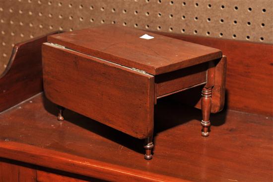 Appraisal: MINIATURE DROPLEAF TABLE Mahogany having rectangular leaves with rounded corners