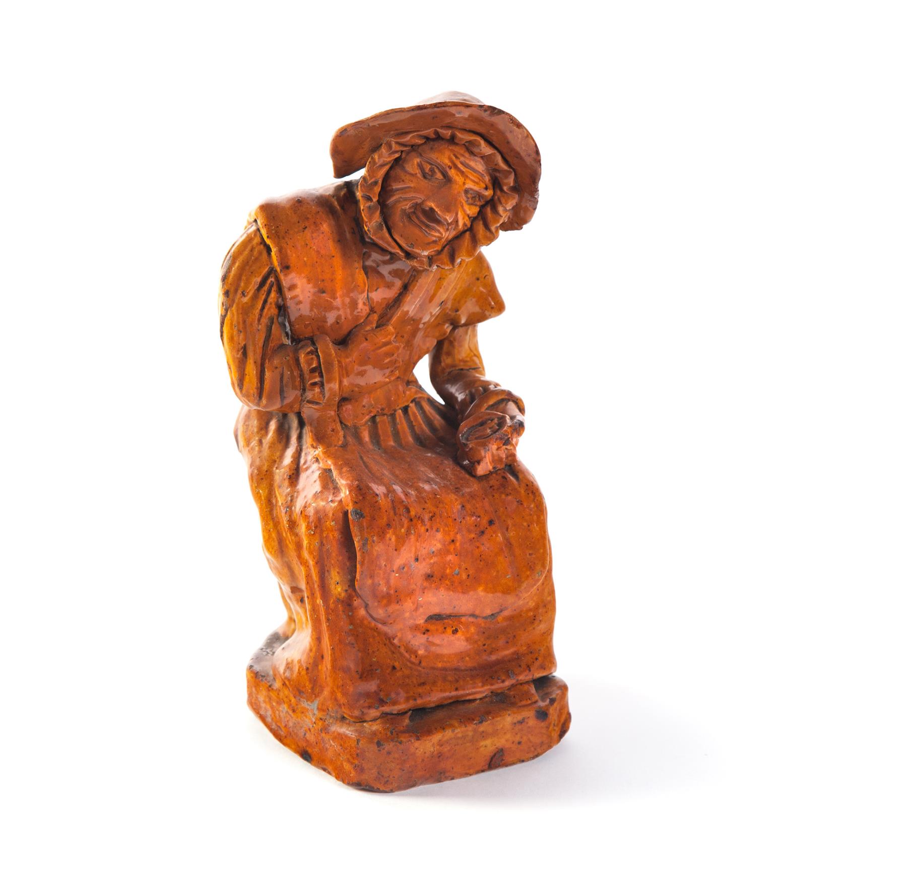 Appraisal: REDWARE FIGURE OF A SEATED OLDER WOMAN American th century