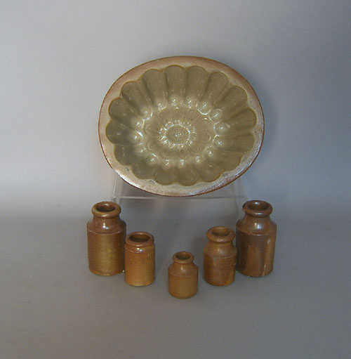 Appraisal: Five miniature stoneware crocks together with a mold h x