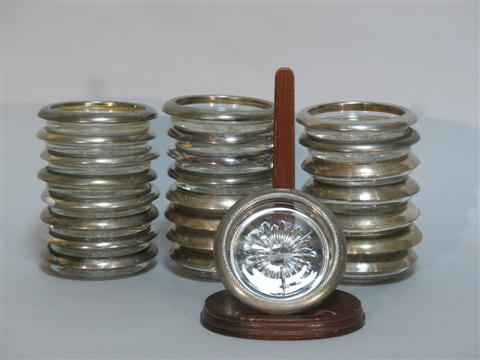 Appraisal: COLLECTION OF TWENTY-FOUR SILVER-PLATED AND GLASS COASTERS Comprising two different