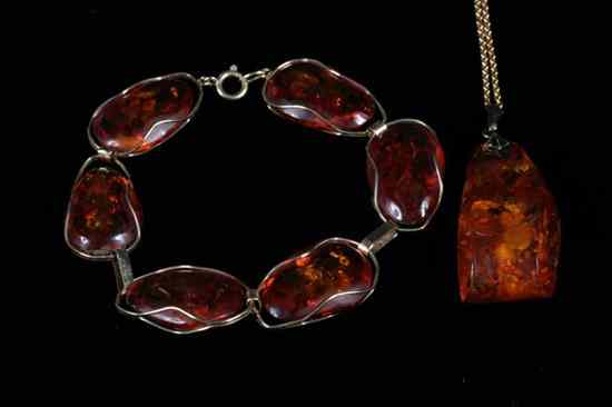 Appraisal: TWO ITEMS AMBER JEWELRY Faceted oblong pendant on yellow gold