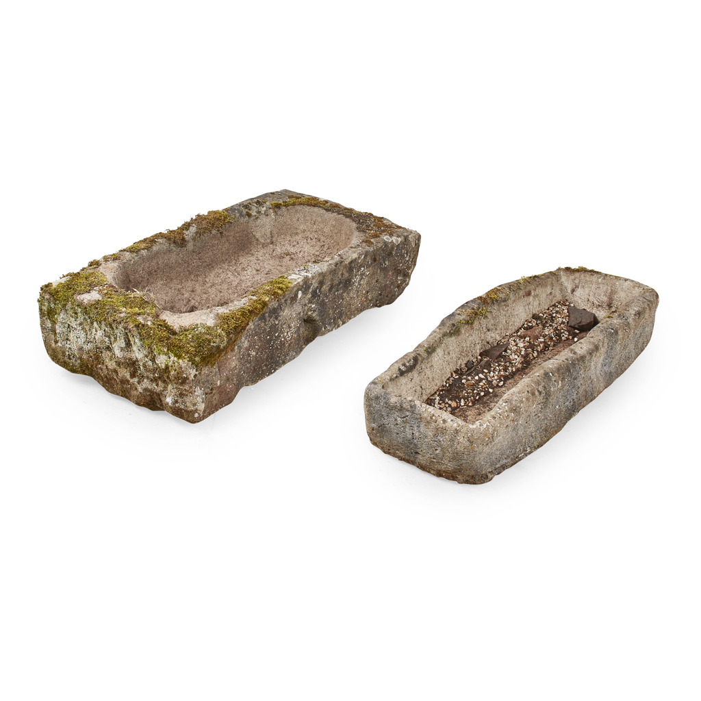 Appraisal: TWO STONE TROUGHS of rough and irregular rectangular shape Larger