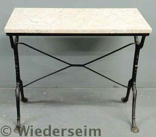 Appraisal: Cast iron patio table with a marble top and shell-form