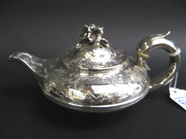 Appraisal: VICTORIAN LONDON STERLING SILVER TEAPOT chased and engraved with scrolls