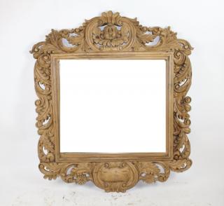 Appraisal: Rococo style carved mirror with focal cherub Natural finish Rococo