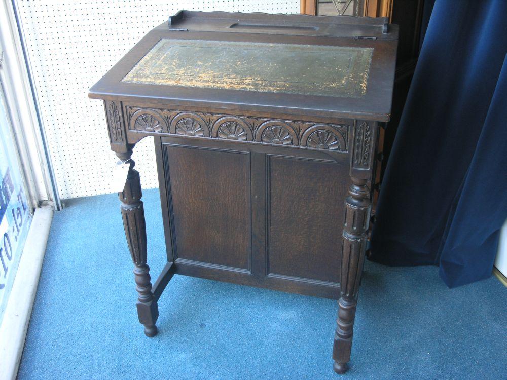 Appraisal: A Victorian style oak Davenport sloping top with inset leather