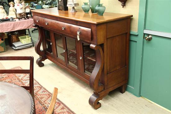 Appraisal: SIDEBOARD Empire cherry Three curved front drawers over four doors